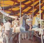 Riding a merry-go-round as a child.
